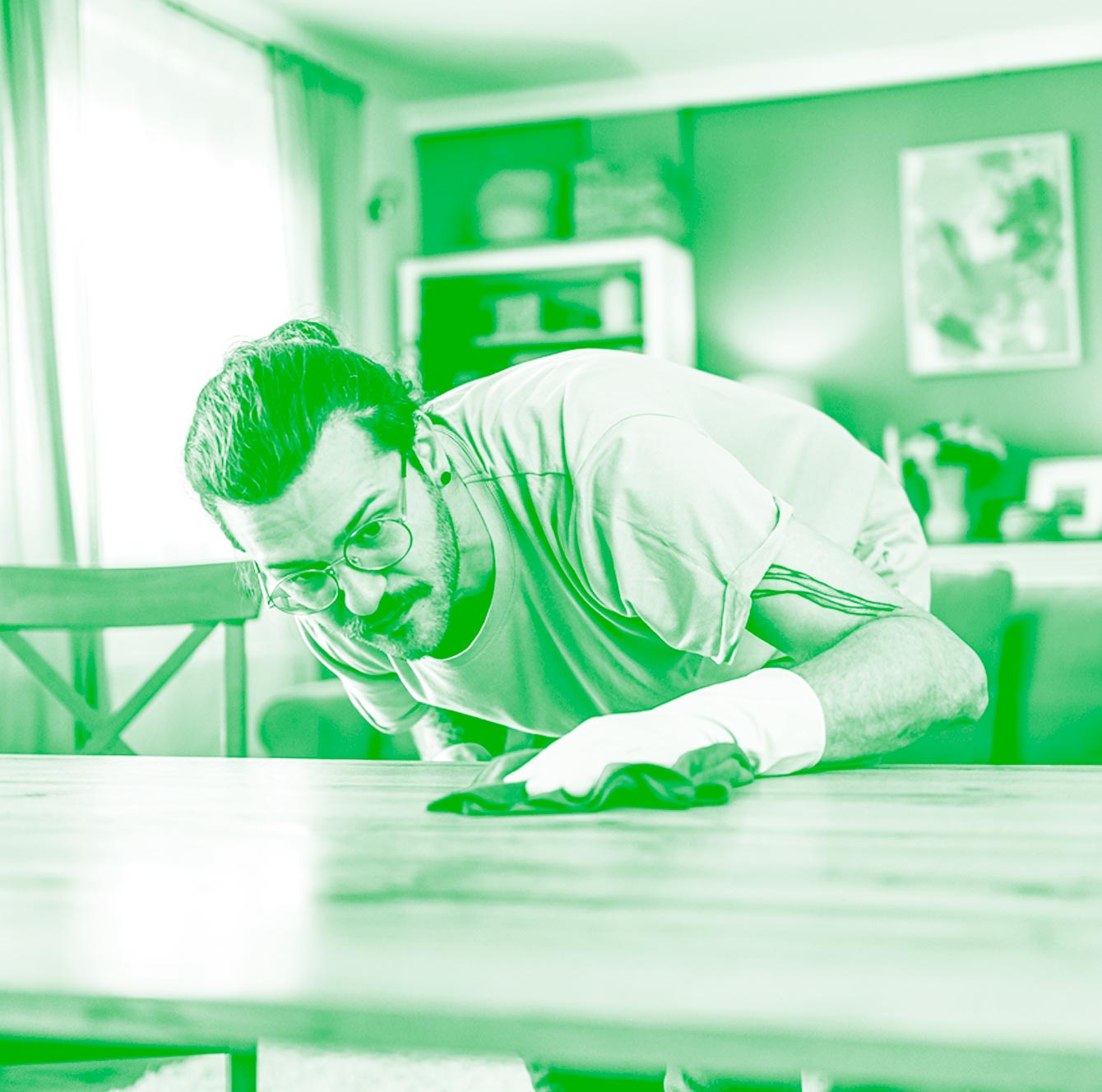 A cleaner wiping down a table